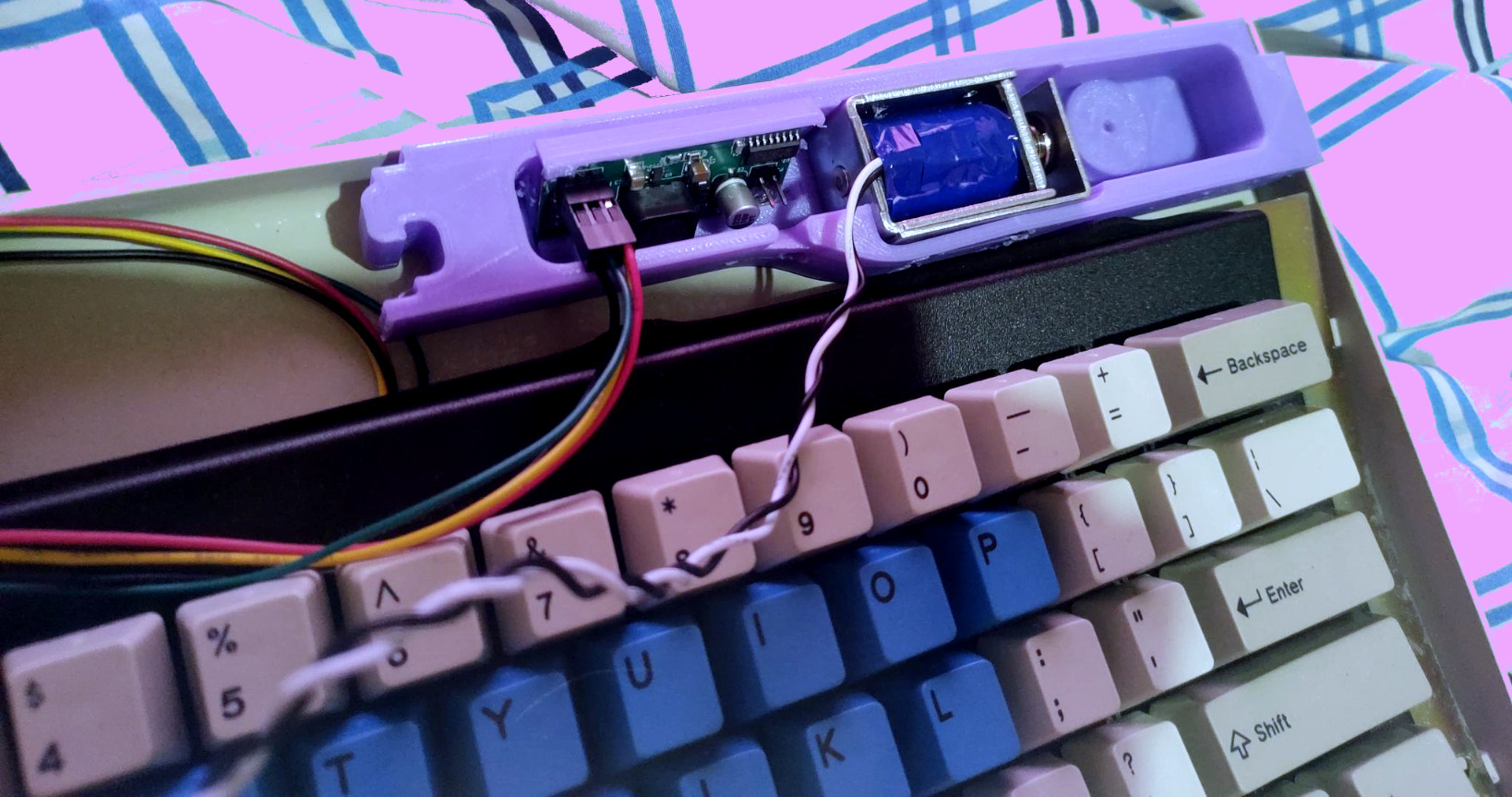 A photo from an angle of a solenoid holder for the Model
		      F62 reproduction keyboard.