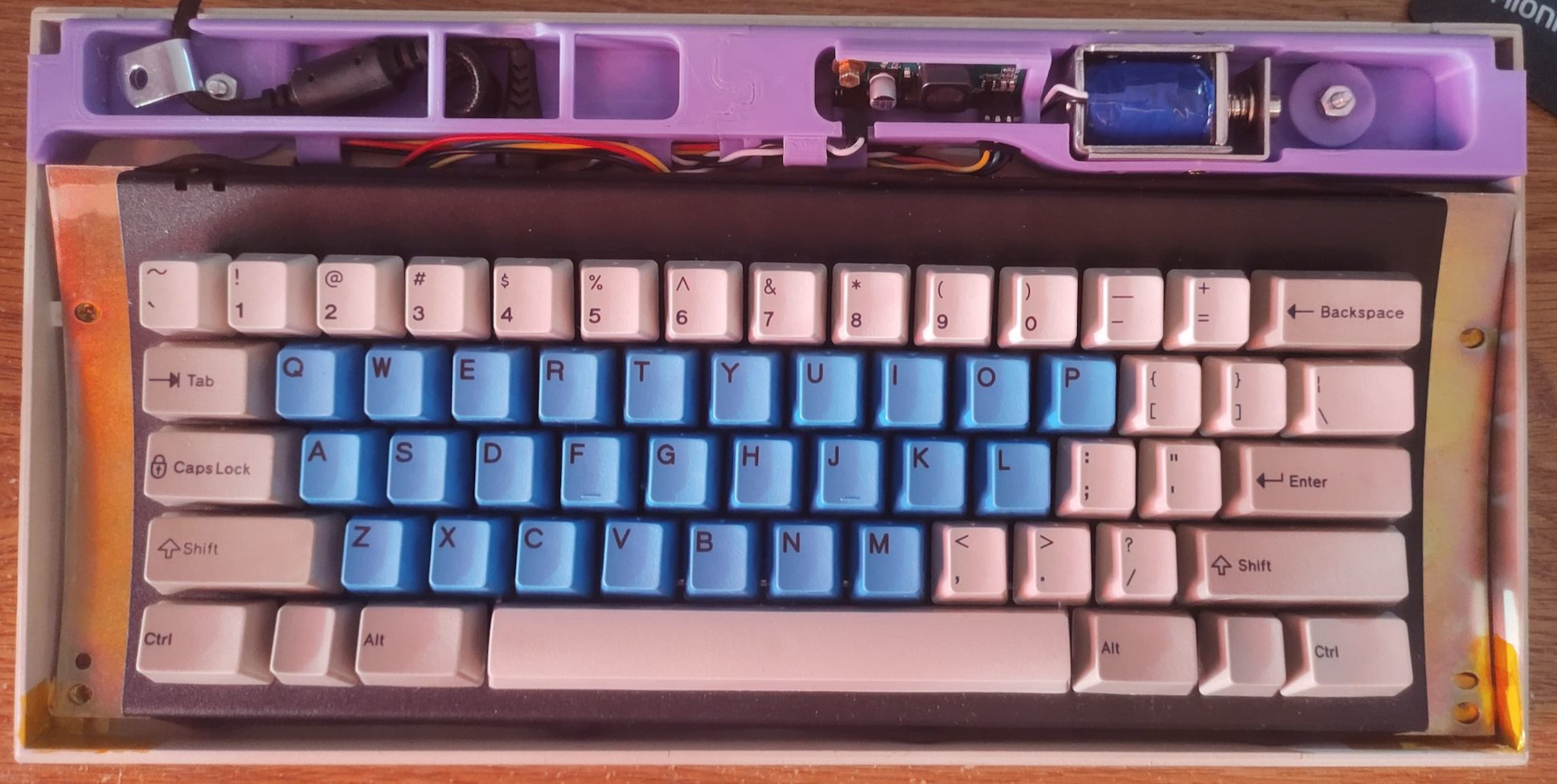 A photo from the top of a solenoid holder for the Model
		      F62 reproduction keyboard.